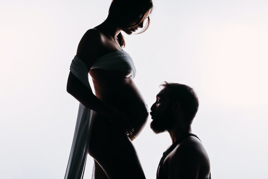 Illustration depicting a man with his hand on his partner's pregnant belly, symbolizing male sympathetic pregnancy.