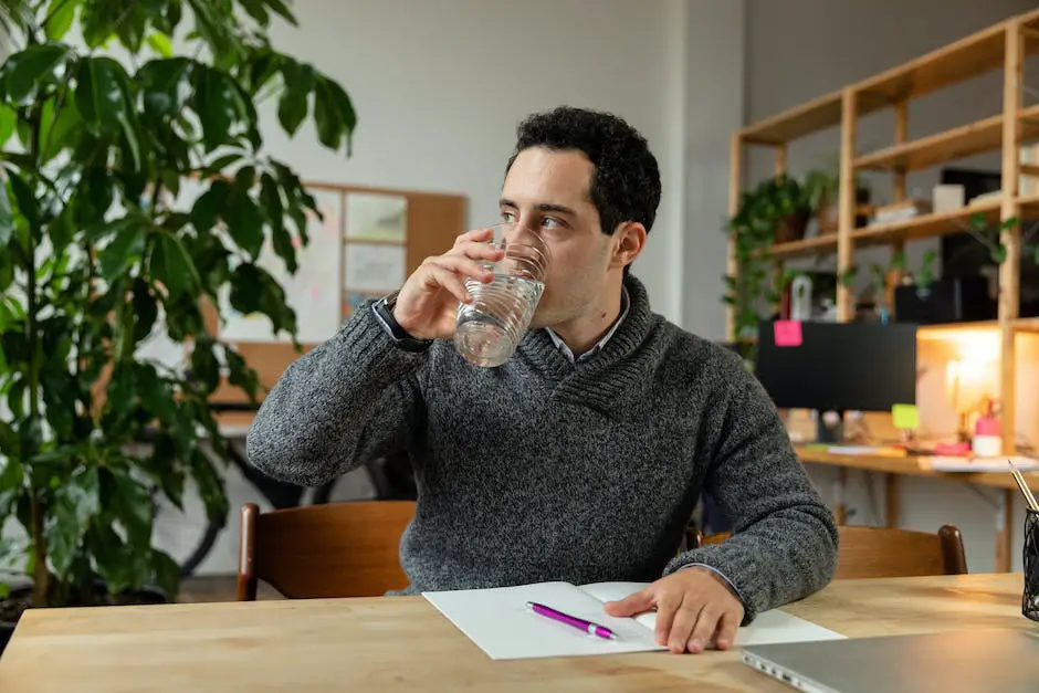 Image depicting a person drinking warm water