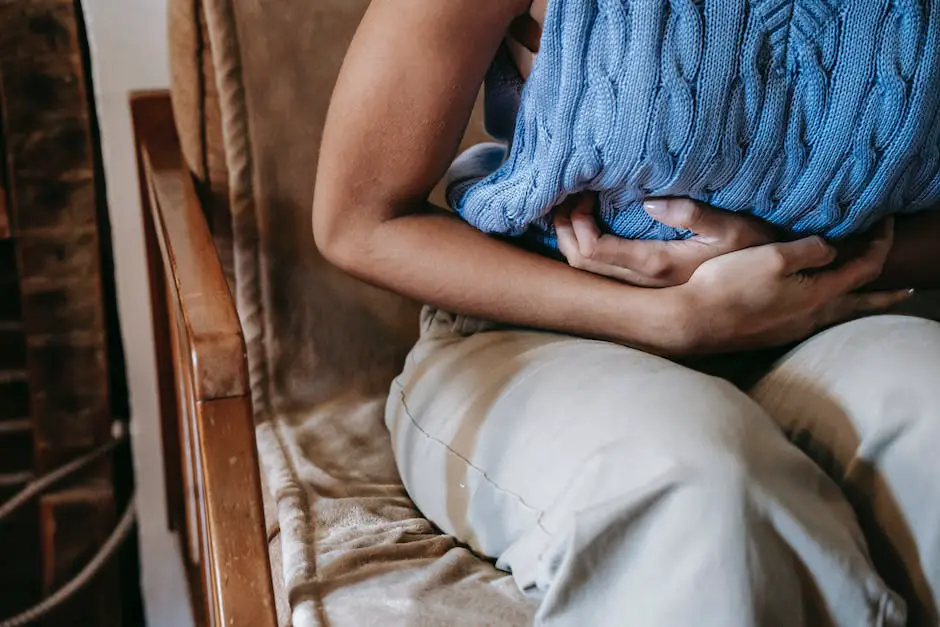 A person holding their stomach in discomfort, representing the discomfort caused by bloating