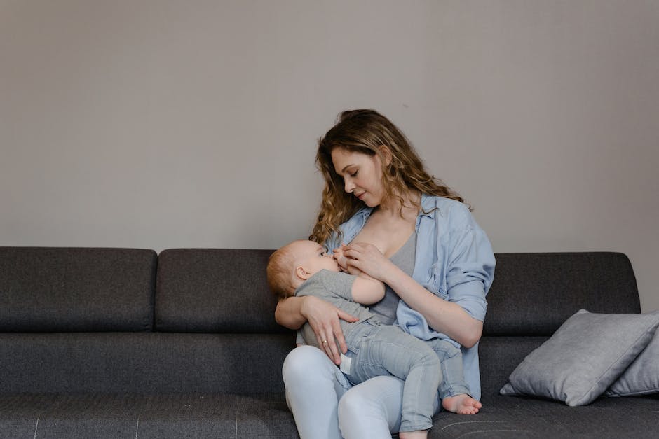 A mother breastfeeding her baby while enjoying a healthy meal