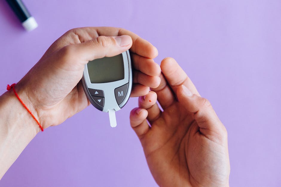 A close-up of a person's hand holding a glucose meter with a blood sugar reading displayed, representing the connection between diabetes and weight.
