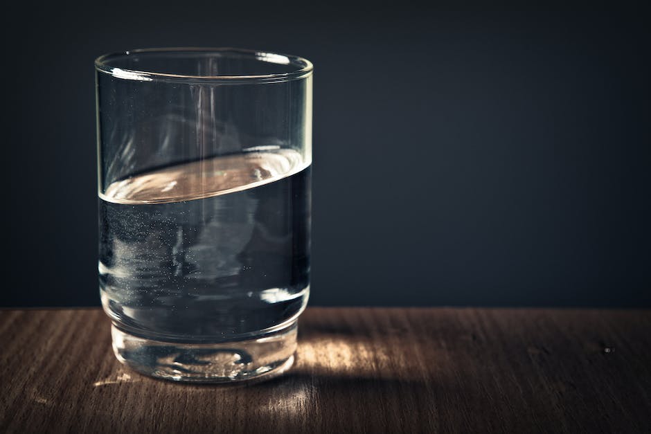 Image depicting a person drinking a glass of water