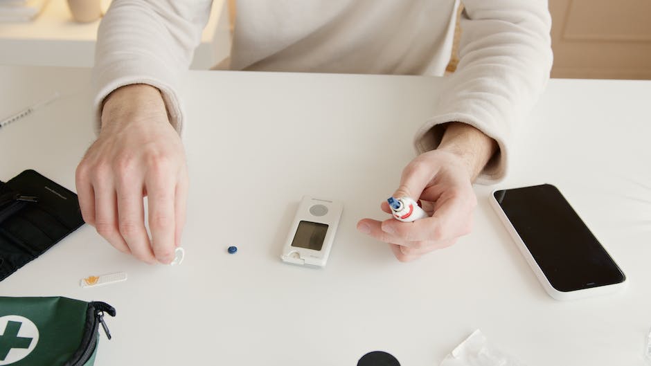 A medical professional performing a blood glucose level test on a patient.