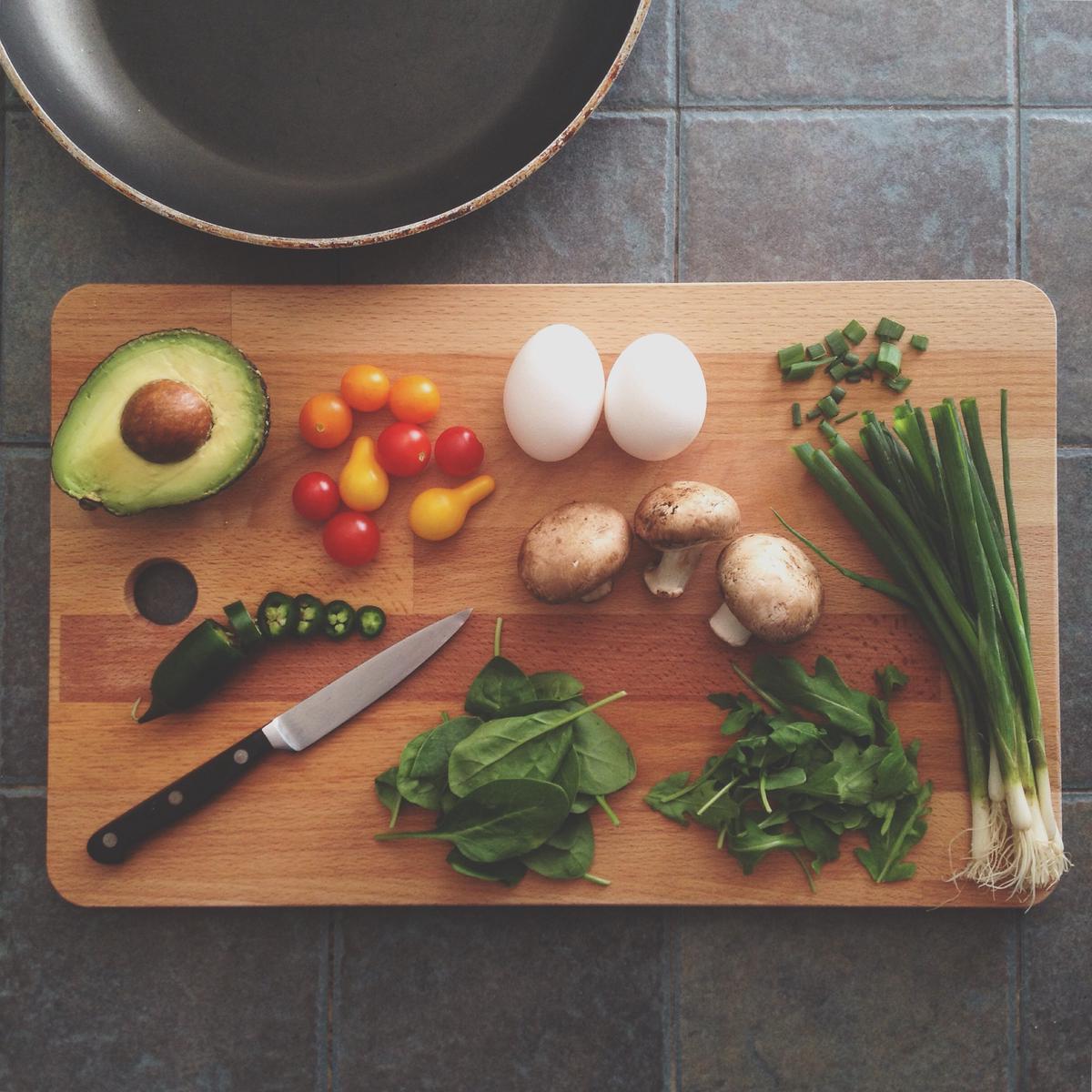 A person preparing a healthy meal with various ingredients.