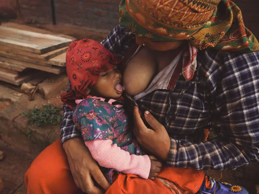 Image depicting a mother breastfeeding her baby at night