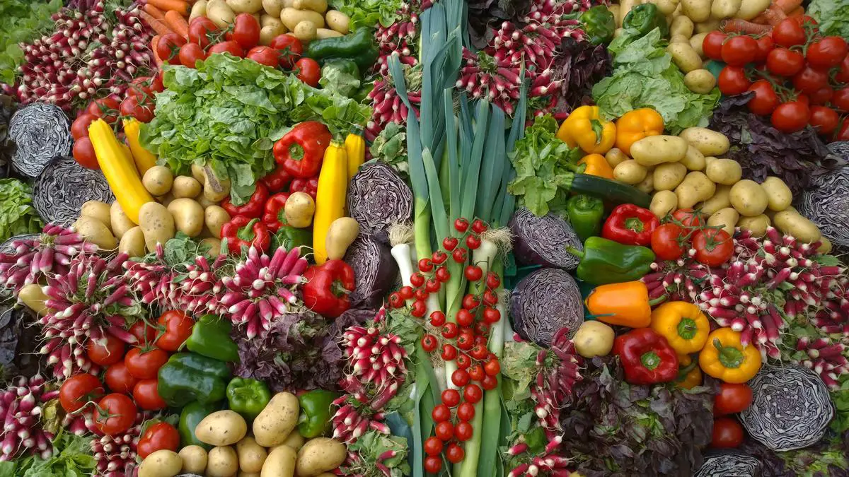 Illustration of fruits and vegetables next to a glass of milk