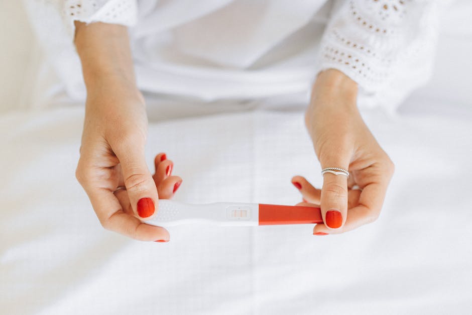 A couple holding a positive pregnancy test, depicting the emotional toll of sympathetic pregnancy