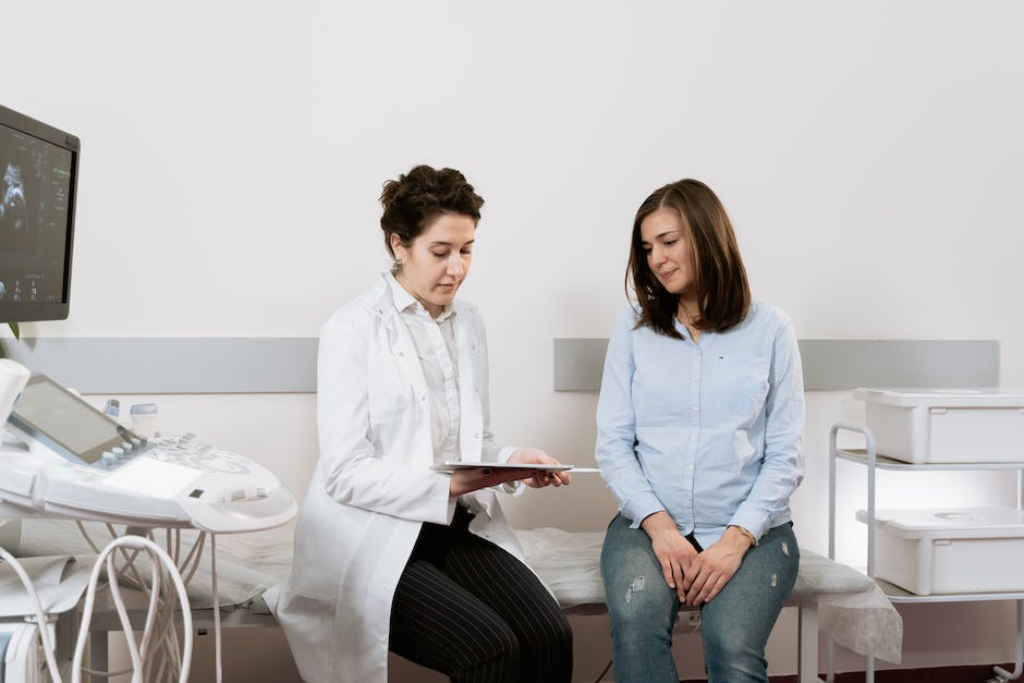 An image depicting a pregnant woman holding her stomach and undergoing a medical test.