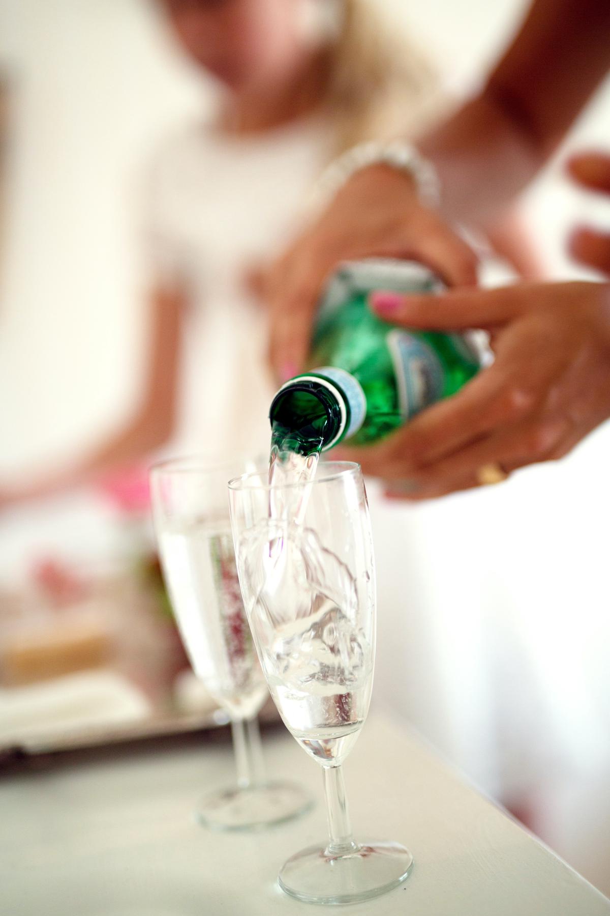 Image of a person drinking water from a glass, emphasizing the importance of hydration.