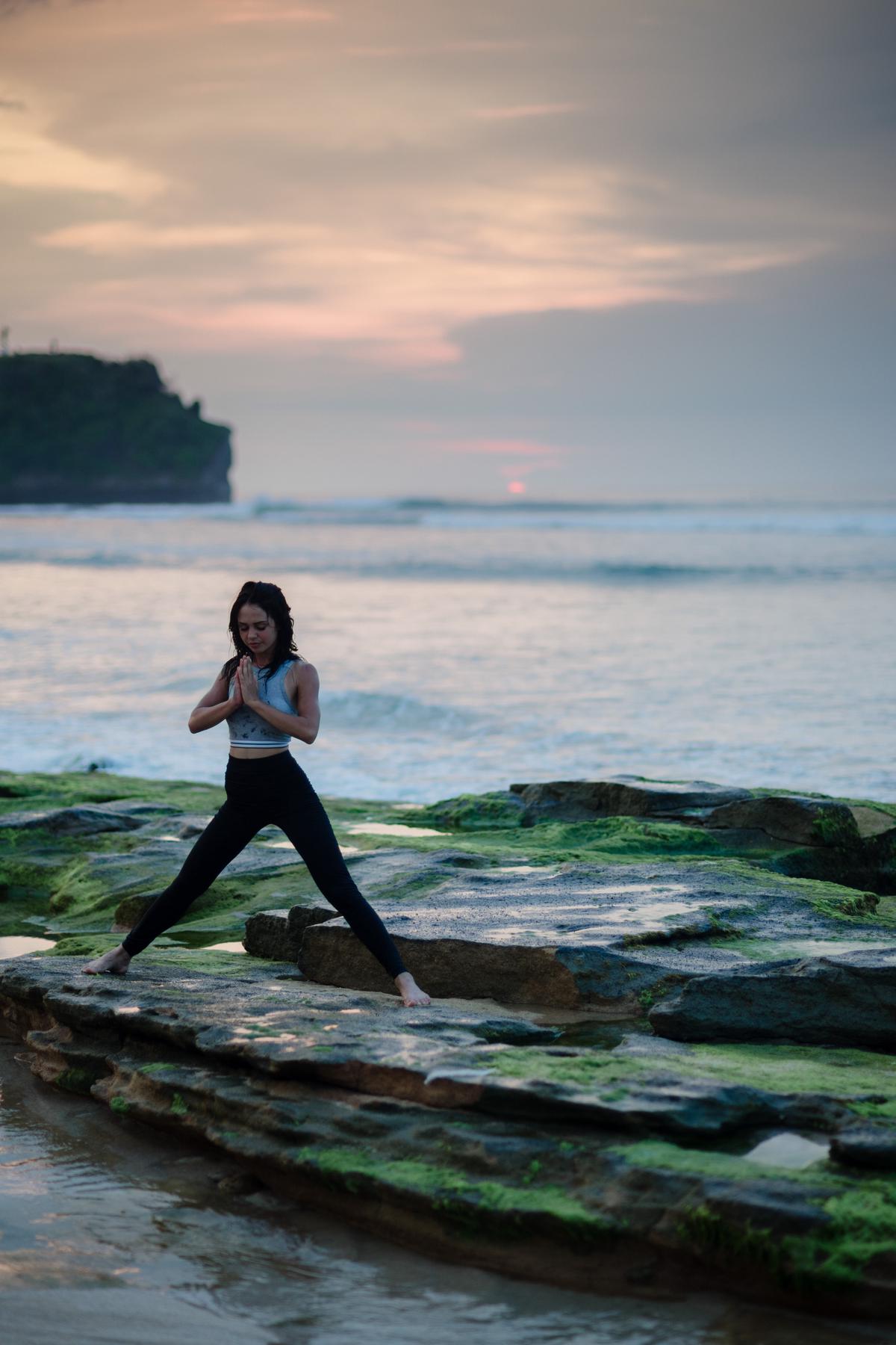 Illustration of a person practicing yoga in a serene natural setting.